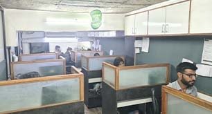 Sales cabin with desks and team members at work